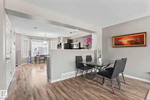 Dining room featuring a textured ceiling and wood finished floors - 3221 Cherry Cres Sw, Edmonton, AB - Indoor Photo Showing Dining Room