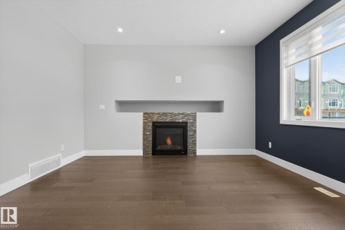 3964 Claxton Loop, Edmonton, AB - Indoor Photo Showing Living Room With Fireplace