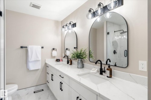 Full bathroom with double vanity, a marble finish shower, and light marble finish floors - 4120 108 Street, Edmonton, AB - Indoor Photo Showing Bathroom