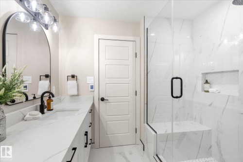 Bathroom with vanity, a marble finish shower, and light marble finish floors - 4120 108 Street, Edmonton, AB - Indoor Photo Showing Bathroom