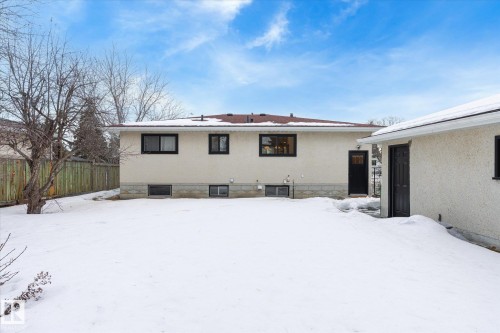 Snow covered rear of property with stucco siding - 4120 108 Street, Edmonton, AB - Outdoor
