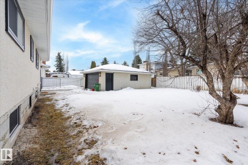 Snow covered rear of property with an outdoor structure and a fenced backyard - 4120 108 Street, Edmonton, AB - Outdoor