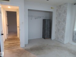 Unfurnished bedroom with a closet and unfinished concrete flooring - 