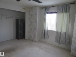 Unfurnished bedroom featuring a ceiling fan, a closet, and a textured ceiling - 