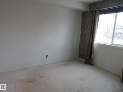 Empty room featuring carpet and baseboards - 