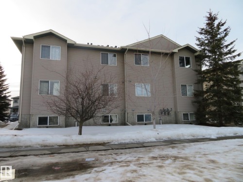 Snow covered property featuring a view of apartment building / complex - 2945 26 Street, Edmonton, AB - Outdoor