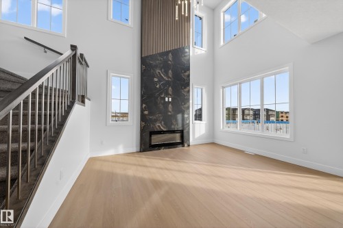 437 Crystal Creek Link, Leduc, AB - Indoor Photo Showing Other Room With Fireplace