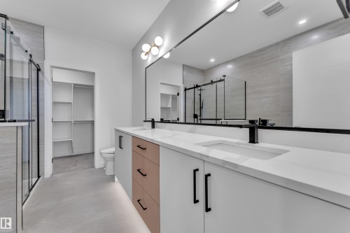 Bathroom featuring double vanity, a stall shower, and a walk in closet - 38 Grayson Green, Stony Plain, AB - Indoor Photo Showing Bathroom