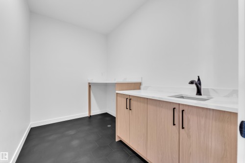 Laundry room with a sink and baseboards - 38 Grayson Green, Stony Plain, AB - Indoor
