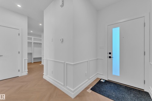 Foyer featuring parquet floors, recessed lighting, a decorative wall, and a wainscoted wall - 38 Grayson Green, Stony Plain, AB - Indoor Photo Showing Other Room