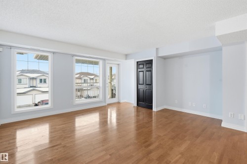 Spare room with a textured ceiling and wood finished floors - 2953 26 Street, Edmonton, AB - Indoor Photo Showing Other Room