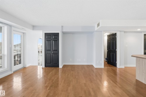 Empty room with light wood finished floors and a textured ceiling - 2953 26 Street, Edmonton, AB - Indoor Photo Showing Other Room