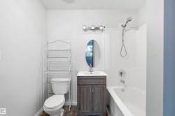 Bathroom featuring vanity,  shower combination, and a textured ceiling - 