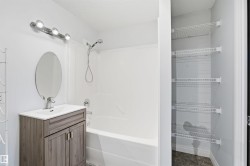 Bathroom featuring shower / washtub combination, vanity, and a textured ceiling - 