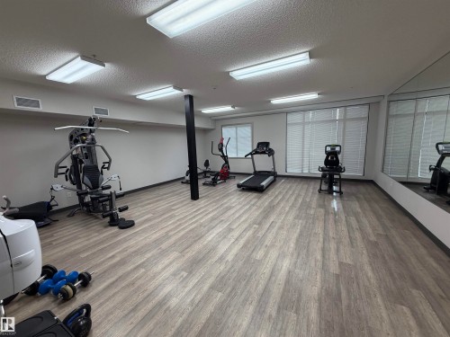 Workout room with a textured ceiling - 417 1004 Rosenthal Boulevard, Edmonton, AB - Indoor Photo Showing Gym Room