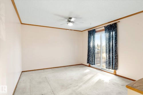 Empty room featuring a ceiling fan, crown molding, light carpet, and a textured ceiling - 12232 135 Street, Edmonton, AB - Indoor Photo Showing Other Room