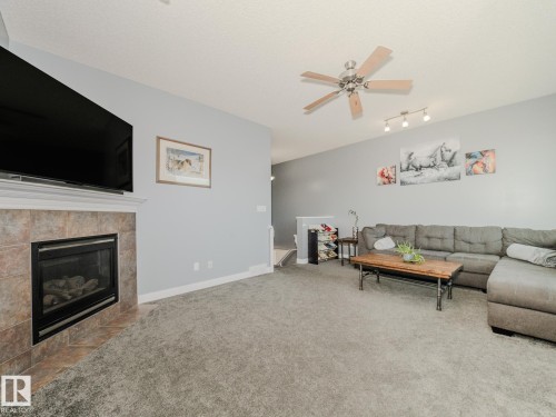 109 Rue Moreau, Beaumont, AB - Indoor Photo Showing Living Room With Fireplace