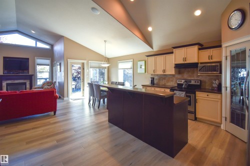 62 Linkside Boulevard, Spruce Grove, AB - Indoor Photo Showing Kitchen With Fireplace