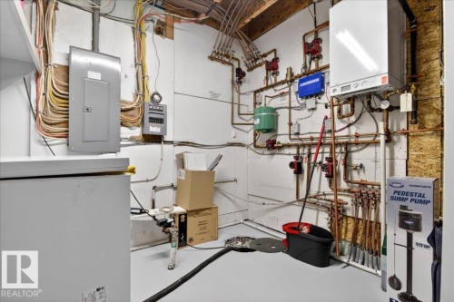 Utilities featuring water heater and electric panel - 5019 48 Avenue, Chipman, AB - Indoor Photo Showing Basement