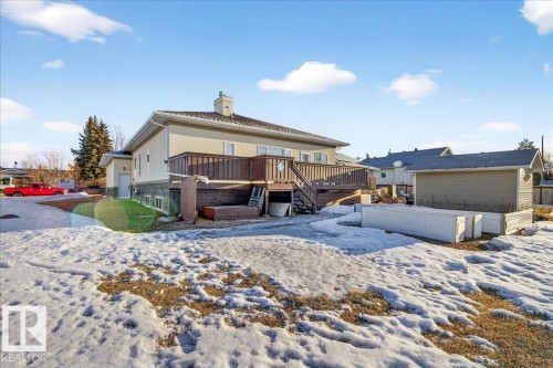 Snow covered rear of property with a wooden deck and a chimney - 5019 48 Avenue, Chipman, AB - Outdoor
