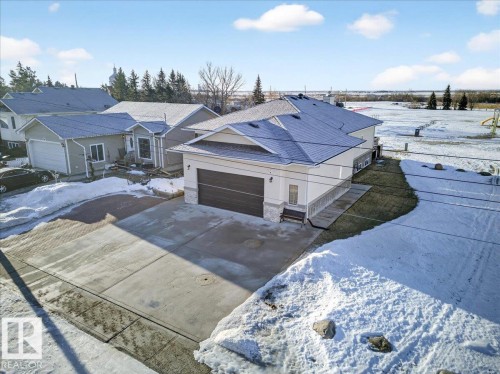 View of front of home featuring driveway and an attached garage - 5019 48 Avenue, Chipman, AB - Outdoor