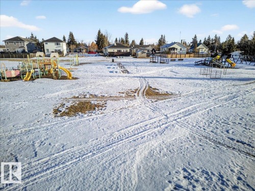 Yard layered in snow with a residential view - 5019 48 Avenue, Chipman, AB - Outdoor