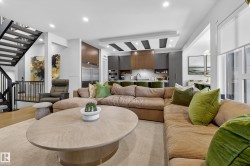 Living room featuring stairway and recessed lighting - 