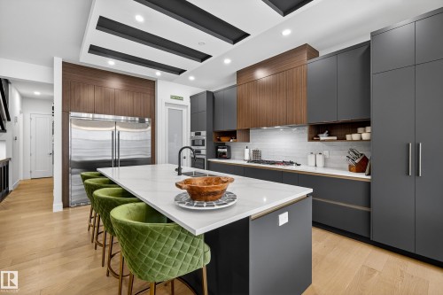 Kitchen with a kitchen bar, modern cabinets, a kitchen island with sink, stainless steel appliances, and recessed lighting - 1132 Wahl Place, Edmonton, AB - Indoor Photo Showing Kitchen With Upgraded Kitchen