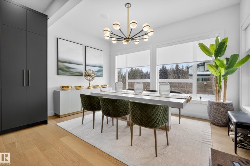 Dining room featuring light wood finished floors and suspended lighting - 1132 Wahl Place, Edmonton, AB - Indoor Photo Showing Dining Room