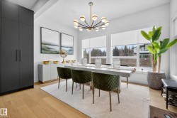 Dining room featuring light wood finished floors and suspended lighting - 
