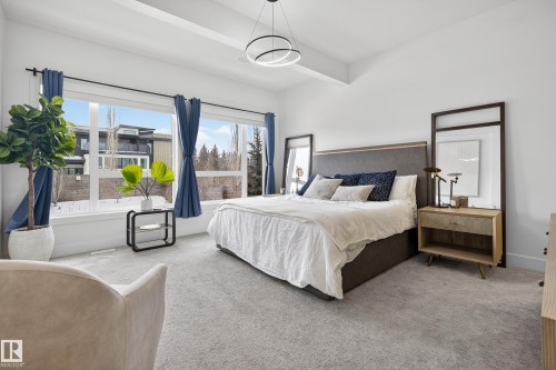 Bedroom with carpet floors and beam ceiling - 1132 Wahl Place, Edmonton, AB - Indoor Photo Showing Bedroom
