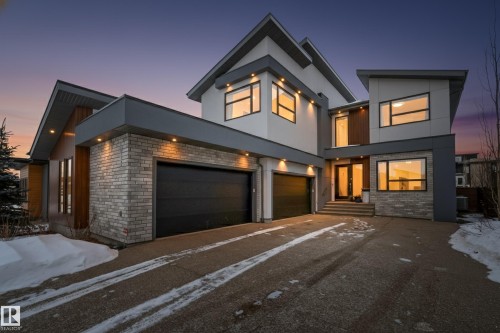 Modern home with stucco siding, brick siding, driveway, and an attached garage - 1132 Wahl Place, Edmonton, AB - Outdoor