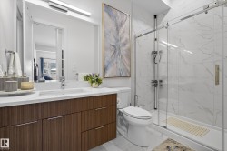 Full bath featuring vanity, a marble finish shower, and light marble finish flooring - 