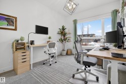 Office area featuring carpet flooring and suspended lighting - 