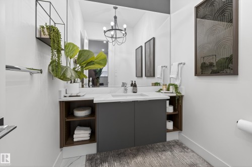 Bathroom featuring vanity and suspended lighting - 1132 Wahl Place, Edmonton, AB - Indoor Photo Showing Bathroom