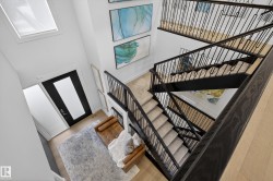 Stairs with a high ceiling and wood finished floors - 