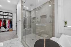 Bathroom featuring a spacious closet, marble look tile flooring, a marble finish shower, recessed lighting, and carpet flooring - 