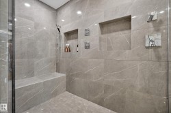 Full bath featuring a marble finish shower - 