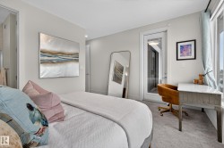 Bedroom with carpet and an office area - 