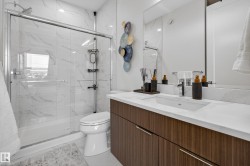 Full bathroom featuring vanity and a marble finish shower - 