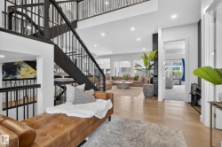 Living area featuring light wood finished floors, recessed lighting, and a high ceiling - 