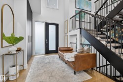 Foyer entrance with light wood-style flooring and a high ceiling - 