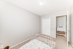 Bedroom with carpet flooring and a closet - 