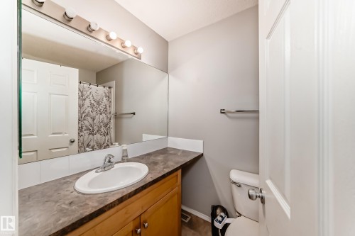 Full bath with a shower with shower curtain and vanity - 185 230 Edwards Drive, Edmonton, AB - Indoor Photo Showing Bathroom