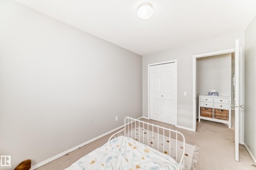 Bedroom with carpet flooring and a closet - 185 230 Edwards Drive, Edmonton, AB - Indoor Photo Showing Bedroom