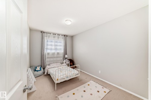 Carpeted bedroom with baseboards - 185 230 Edwards Drive, Edmonton, AB - Indoor Photo Showing Bedroom