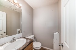 Half bath with vanity and a textured ceiling - 