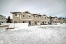 Snow covered property featuring a chimney and a residential view - 185 230 Edwards Drive, Edmonton, AB  - Outdoor 