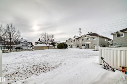 Yard layered in snow featuring a residential view - 185 230 Edwards Drive, Edmonton, AB - Outdoor
