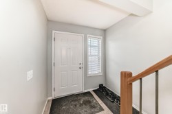 Foyer entrance with stairs and baseboards - 